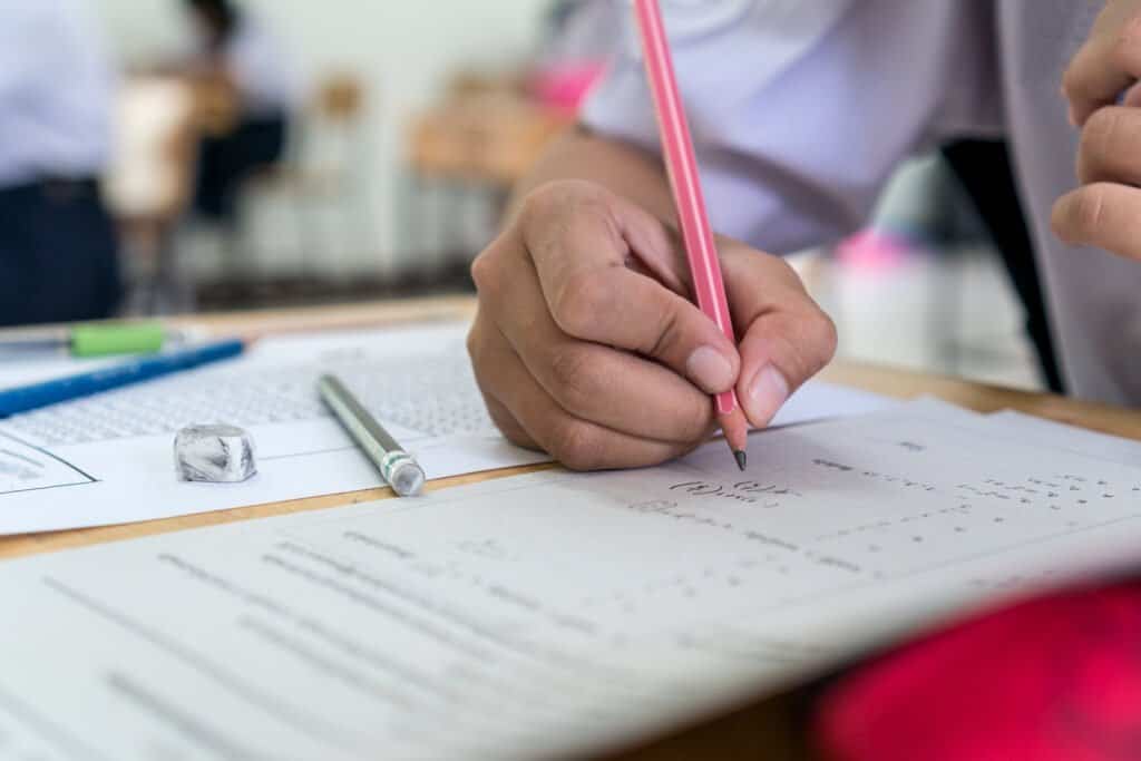Students Hands Taking Exams, Writing Examination Room With Holdi